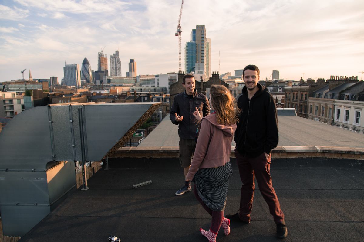 People on an East London rooftop over looking the city buildings