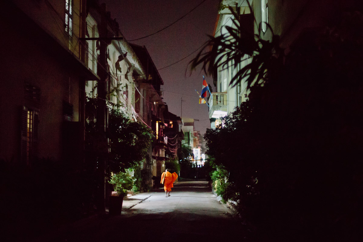 Monk walking in the street at a monastery in night in Phnom Penh